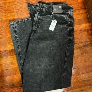 Rigid black denim jeans with distressing